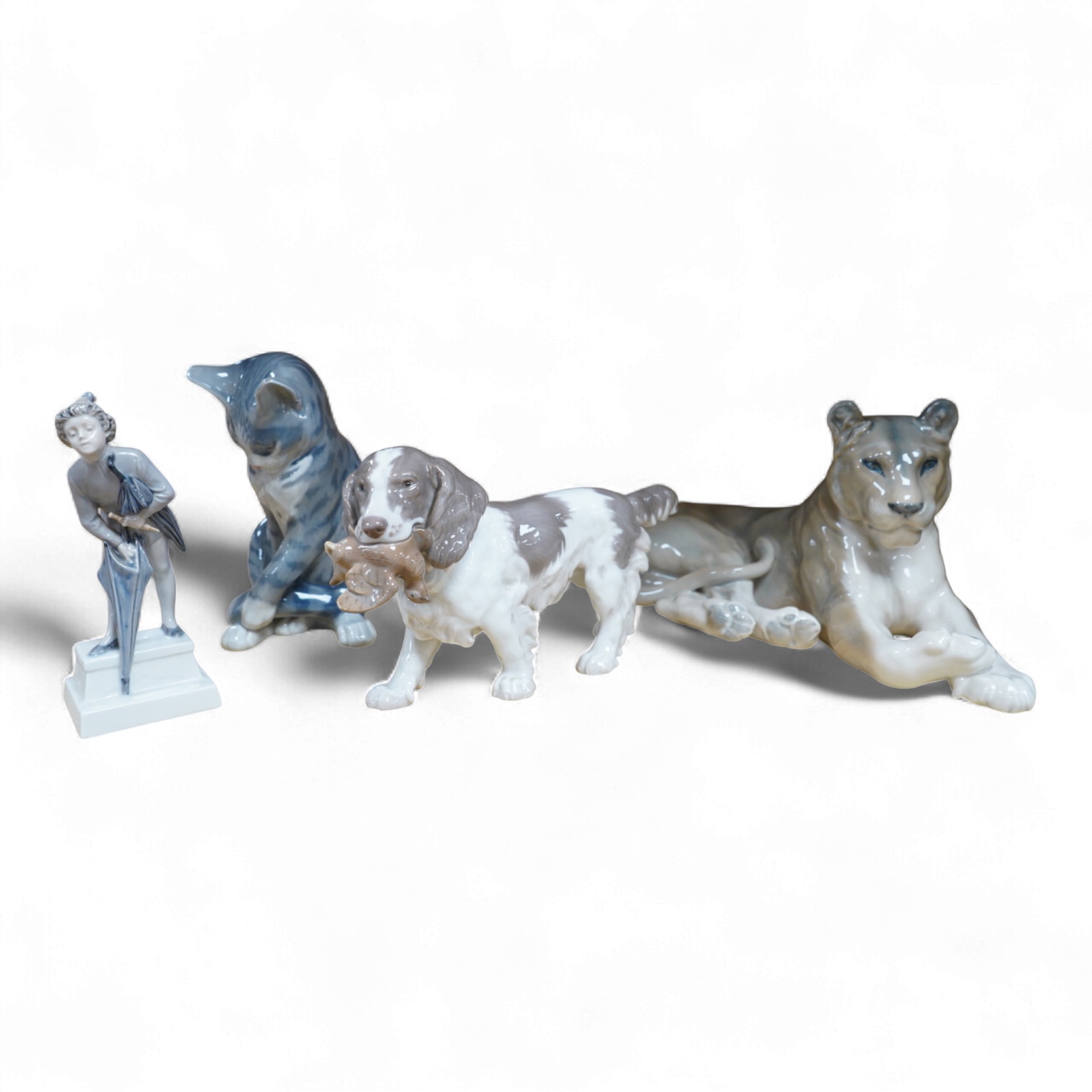 A Royal Copenhagen figure, 'The Sandman', Number 1129, a similar cat, number 340, a B&G spaniel and a Danish lion, tallest 18.5cm